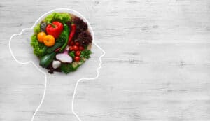 Plate of Vegetables in the Middle of Womans Head Outline